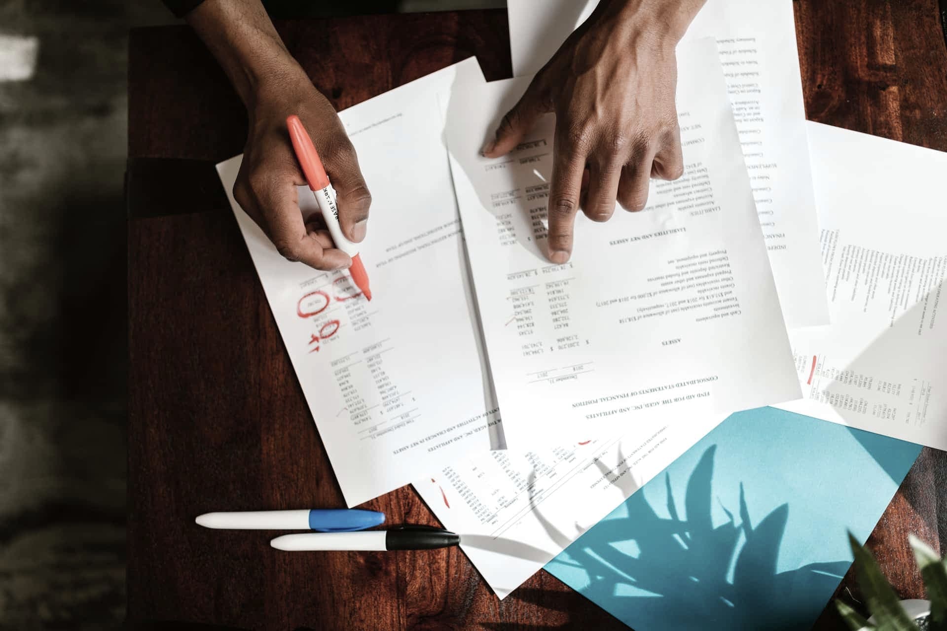 A desk with paperwork and a notebook