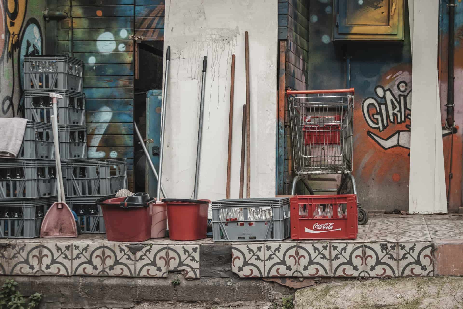 A bucket and mop standing beside cleaning supplies