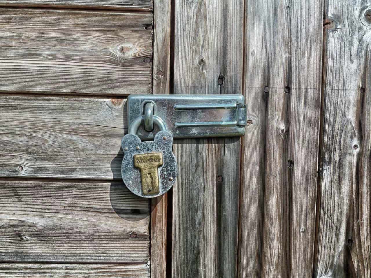 A padlock fastened on a wooden door